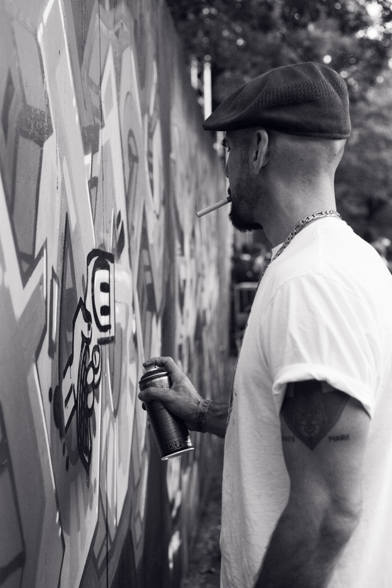 Graffiti artist working on a mural.