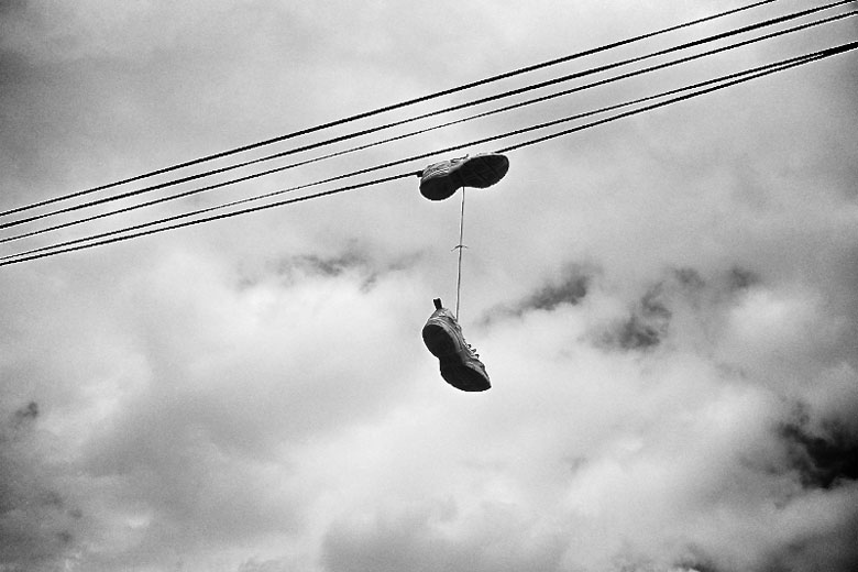 Sneakers hanging off of power line.
